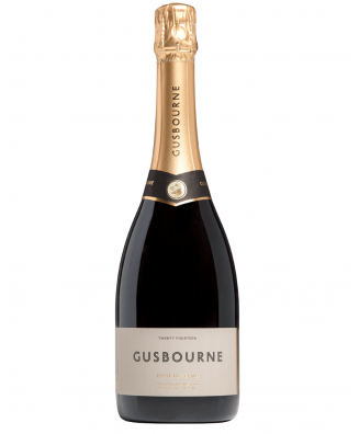 Bottle of Gusbourne Brut Reserve sparkling wine with a golden label and black text detailing the brand and variety.